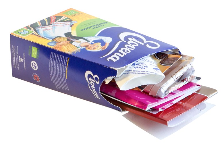 A colourful carton oatmeal package with other flattened carton packaging stuffed inside it.